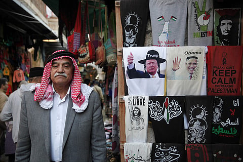 A t-shirt depicting US President-elect Donald Trump with a superimposed hat worn by Orthodox Jews and locks, is seen next to a t-shirt depicting President Barack Obama wearing a traditional Arab headdress in Jerusalem's old city. (File Photo | AP)