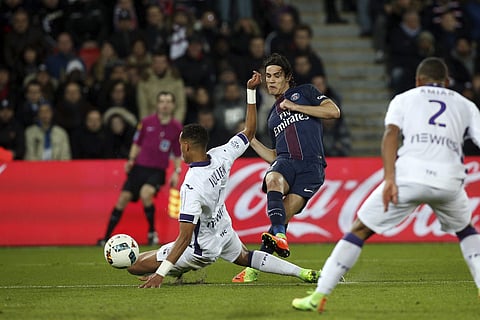 PSG's Edinson Cavani, center, shoots past Toulouse's Christopher Jullien during their League One soccer match, at the Parc des Princes stadium, in Paris, France, Sunday, Feb. 19, 2017.  | AP