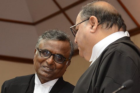 Justice N K Sudhindra Rao shares a light moment with Chief Justice Subhro Kamal Mukherjee at the swearing in ceremony in Bengaluru on Tuesday | Pushkar V