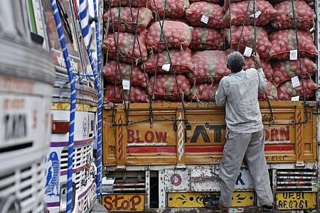 A labourer prepares to unload sacks of potatoes from a truck at a wholesale vegetable and fruit market. (File Photo | Reuters)