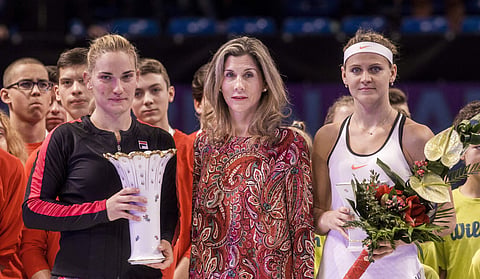 Winner Timea Babos of Hungary, left, and runner-up Lucie Safarova of the Czech Republic, right, pose for a photograph with retired professional tennis player Monica Seles after their final match at the Hungarian Ladies Open tennis tournament in Budapest. 