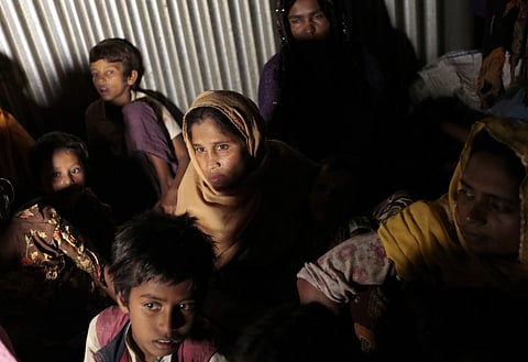 In this Dec. 2, 2016 file photo, Rohingya Muslims from Myanmar, who recently crossed over to Bangladesh, huddle in a room at an unregistered refugee camp in Teknaf, near Cox's Bazar, a southern coastal district about, 296 kilometers (183 miles) south of D