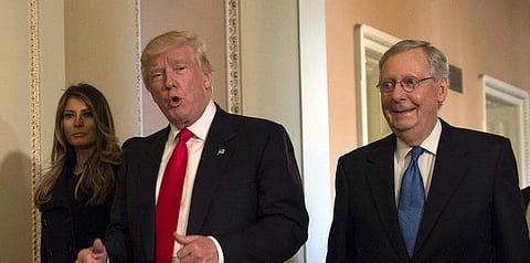 Donald Trump, accompanied by his wife Melania, and Senate Majority Leader Mitch McConnell of Ky. (File Photo | AP)