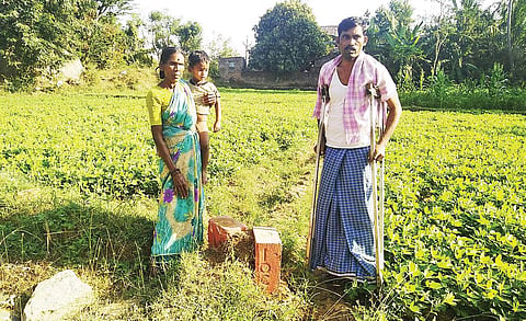 K Venugopal, a farmer, along with his family near the IOC milestone in his agricultural land | s dinesh