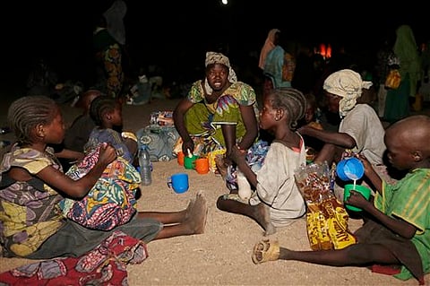 Women and children rescued by Nigerian soldiers from Boko Haram extremists at Sambisa Forest eat a meal together after arriving with others at a refugee camp in Yola, Nigeria. |File Photo: AP