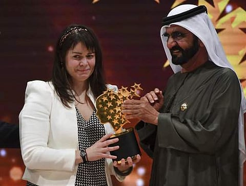 Canadian school teacher Maggie MacDonnell, receives the Global Teacher Prize from Dubai ruler Sheikh Mohammed bin Rashid Al Maktoum, in Dubai, United Arab Emirates. AP