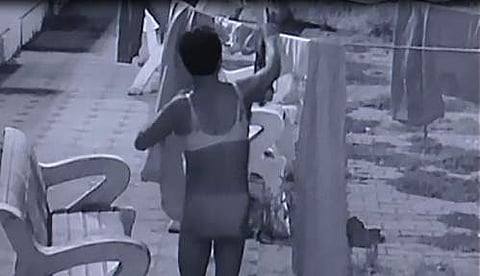 The clip shows the man strutting around the laundry section of the campus, stealing and wearing lingerie.