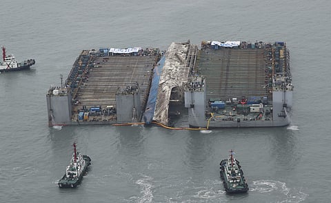 The partially lifted sunken ferry Sewol, center, is ready for transport in waters off Jindo, South Korea, Friday, March 24, 2017. | AP