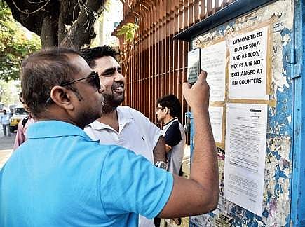 People checking the notice put up outside the RBI in Hyderabad on Thursday | R SATISH BABU