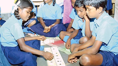Teachers undergoing training at a programme organised by Vijnana Vedike in HD Kote taluk; a teacher demonstrating an experiment at a government school in Saragur; students of a school engaged in activity | Express