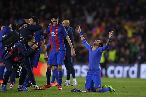 Barcelona's Neymar, celebrates with Barcelona's Sergio Busquets at the end of the Champions League round of 16 second leg football match FC Barcelona vs Paris Saint-Germain FC at the Camp Nou stadium in Barcelona. AP