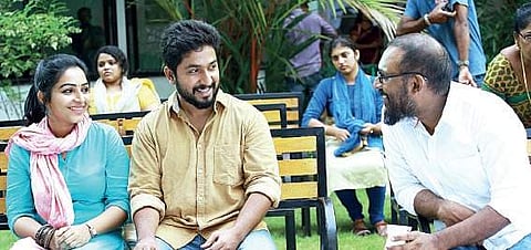 Director Leo Thaddeus with Vineeth Sreenivasan and Rajisha Vijayan on the sets of Oru Cinemakkaran