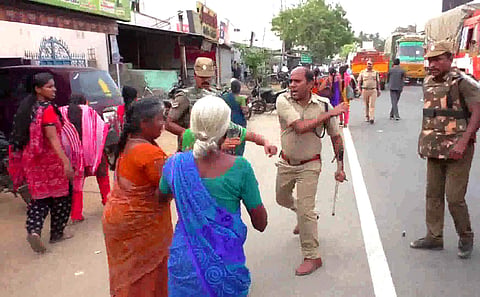 Additional Superintendent of Police Pandiarajan assaulting a woman protester at Samalapuram near Palladam in Tirupur district on Tuesday | Express