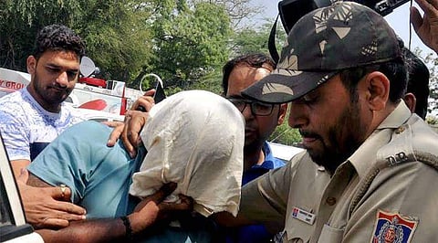 Officials of Delhi Police Crime Branch escort Sukesh Chandra the middleman accused of receiving a bribe after promising to retrieve the party symbol for AIADMK in New Delhi. (File Photo | PTI)
