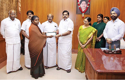 Chief Minister ‘Edappadi’ K Palaniswami presenting a cheque for D5 lakh to a family member of a fisherman who lost a boat
