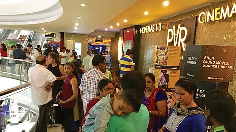 People waiting outside a multiplex bofore the screening of Baahubali-2 in Bengaluru on Thursday night.