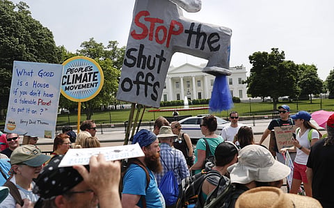 Participants walk along Pennsylvania Ave., in front of the White House in Washington, during a demonstration and march, Saturday, April 29, 2017.  | AP