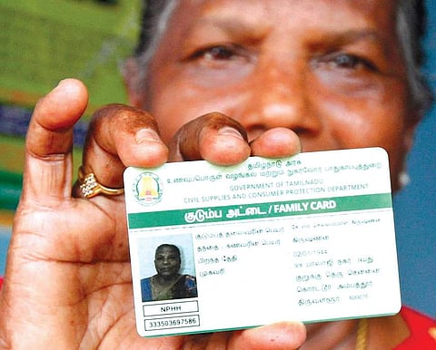 A woman displaying her smart public distribution system card at a ration  shop in Korattur | Express