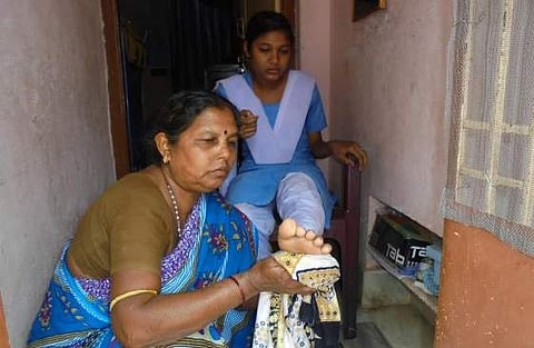 Sujata Kausalya’s mother providing cold water treatment to her daughter’s feet   | Express
