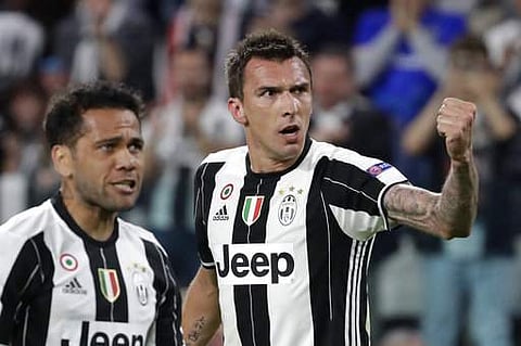 Juventus' Mario Mandzukic, right, celebrates after scoring his side's opening goal besides team mate Dani Alves during the Champions League semi final second leg soccer match against Monaco in Turin. | AP
