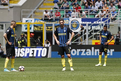 Inter Milan's Mauro Icardi, left, stands with his teammates Roberto Gagliardini, center, and Jeison Murillo after Sassuolo's Pietro Iemmello scored during the Serie A soccer match between Inter Milan and Sassuolo at the San Siro stadium in Milan, Italy, S