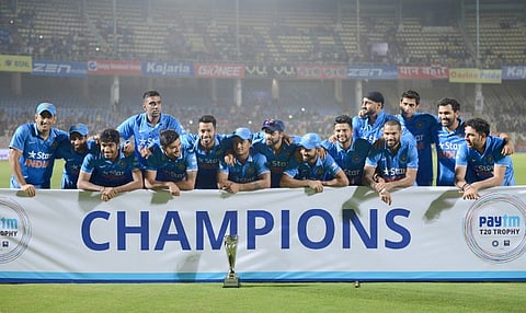 Indian cricket team pose with paytm T20 champions Trophy during the third T20 international match between India and Sri Lanka at the Dr. Y.S. Rajasekhara Reddy ACA-VDCA Cricket Stadium in Visakhapatnam on February 14, 2016.
