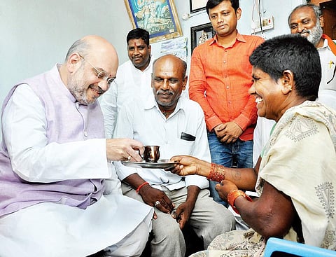BJP national president Amit Shah having tea at a house in Peddadevulapally village of Thripuraram mandal in Nalgonda district on Tuesday |  Express photo