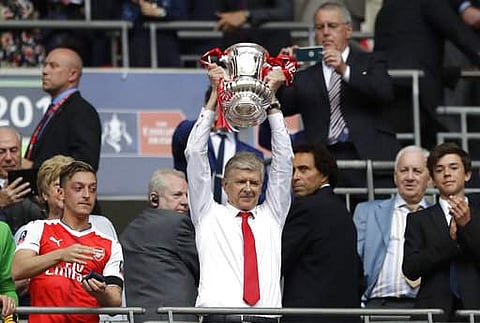 Arsenal team manager Arsene Wenger celebrates with the trophy after winning the English FA Cup final soccer match between Arsenal and Chelsea at Wembley stadium in London. | AP