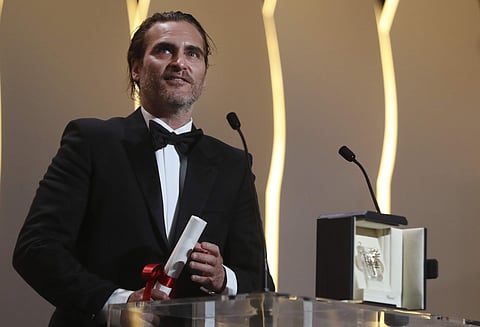 Actor Joaquin Phoenix with his Best Actor award for the film You Were Never Really Here make a short speech during the awards ceremony at the 70th international film festival, Cannes, southern France, Sunday, May 28, 2017.(AP)
