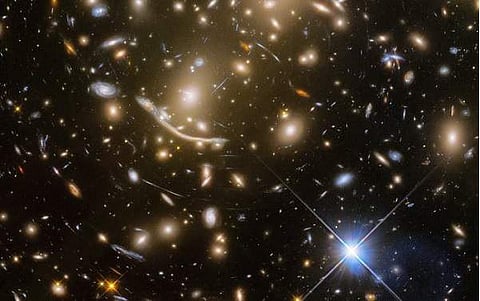 The galaxy cluster called Abell 370 contains an astounding assortment of several hundred galaxies tied together by the mutual pull of gravity.  (Photo: NASA, ESA/Hubble)