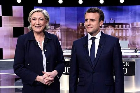 French presidential election candidate for the far-right Front National (FN) party, Marine Le Pen (L) and French presidential election candidate for the En Marche ! movement, Emmanuel Macron. (AFP)