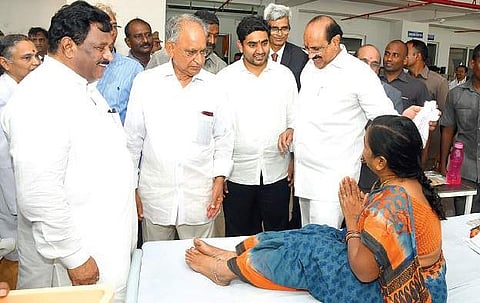 IT minister N Lokesh interacts with patients at GIMSR Hospital on Saturday as minister K Srinivasa Rao and GITAM president MVVS Murthi look on  | Express