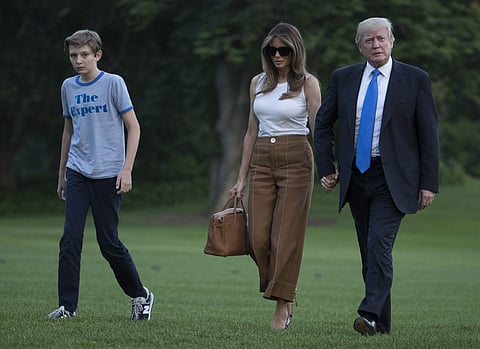 President Donald Trump, first lady Melania Trump, and their son and Barron Trump walk from Marine One across the South Lawn to the White House in Washington on Sunday. (Photo | AP)