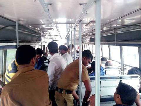 Excise officials checking the belonging of the passengers at Amaravila checkpost