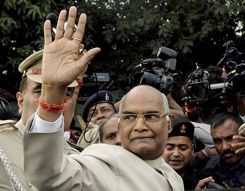 Bihar Governor Ram Nath Kovind NDA's presidential candidate waves at the media as he leaves for Delhi at Raj Bhavan in Patna on Monday. (PTI)