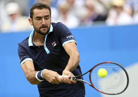 Croatia's Marin Cilic returns the ball to Luxembourg's Gilles Muller during the semifinal at the Queen's Club tennis tournament in London. | AP