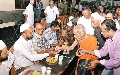 Sri Vishwesha Thirtha swamiji hosting an iftar event at the dining hall of Krishna temple in Udupi on Monday  | Express