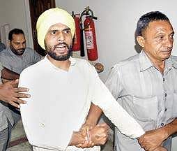 A man being whisked away by security personnel after he, along with another person, threw paper missiles inside the Delhi Assembly while a session was underway, in New Delhi on Wednesday | pti