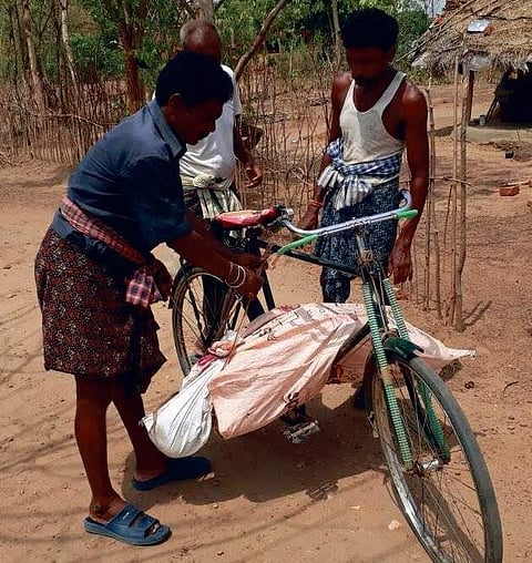 The body of the old woman being taken on a bicycle.
