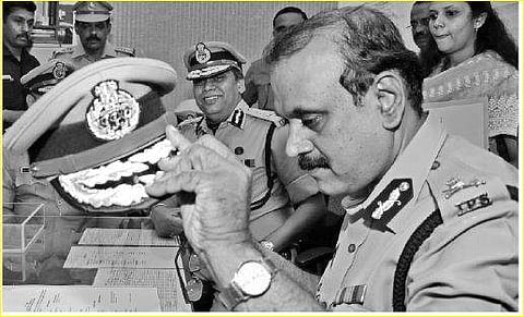 DGP T P Senkumar takes off his official cap as he steps down after an eventful innings as the state police chief on Friday, while his successor Loknath Behera and others look on at a ceremony held at the police headquarters in T’Puram | B P Deepu