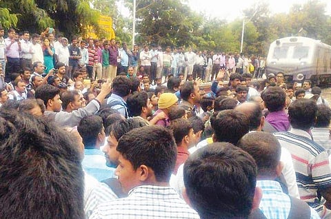 Passengers blocking the railway tracks near Karmelaram station on Thursday