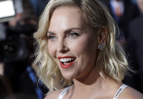 Actress Charlize Theron talks to journalists as she arrives for the world premiere of the movie 'Atomic Blonde' in Berlin, Germany, Monday, July 17, 2017. | AP