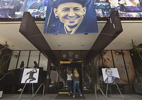 Banners showing photographs of singer Chester Bennington, the frontman for the rock band Linkin Park, are displayed on the front of the Warner Bros. Records offices in Burbank, Calif., Friday, July 21, 2017.  | AP