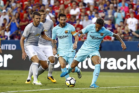 Barcelona's Neymar, right, scores a goal in front of teammate Lionel Messi, center, Manchester United's Michael Carrick, left, and Victor Lindelof during the first half of an International Champions Cup soccer match. | AP