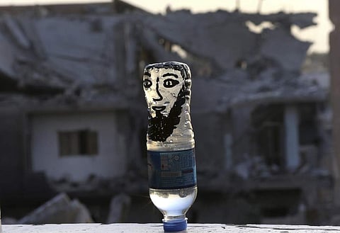 The city of Raqqa in Syria, which now serves as Islamic State group's de facto capital, witnesses heavy fighting as US-backed Syrian fighters push for the control and liberation of the city from the extremists. A water bottle painted with a face to represent an IS extremist on a window sill on the front line in Raqqa on Thursday. (Photo | AP)