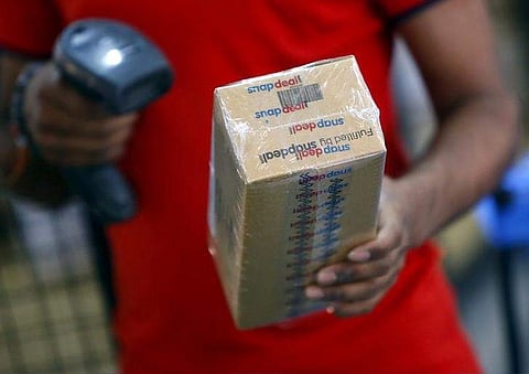 A worker of Indian e-commerce company Snapdeal.com scans barcode on a box after it was packed at the company's warehouse in New Delhi April 20, 2015. (REUTERS/Anindito Mukherjee/File Photo)