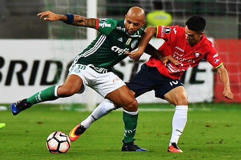 Felipe Melo (L) of Brazil's Palmeiras, jump for the ball with Jorge Ortiz of Bolivia's Jorge Wilstermann  | AFP