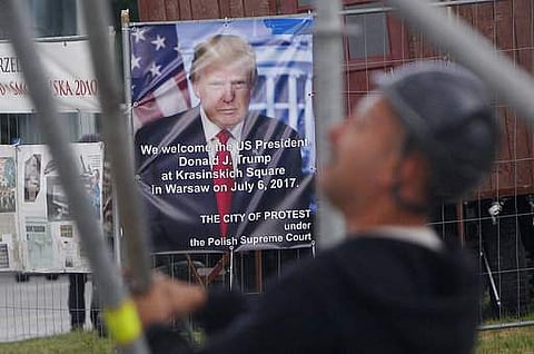 Workers build a podium that President Donald Trump will speak from durin a visit to Poland this week in Krasinski Square in Warsaw, Poland, Monday, July 3, 2017. Trump will be in Warsaw before traveling to Germany for a G20 summit of top world leaders. (F