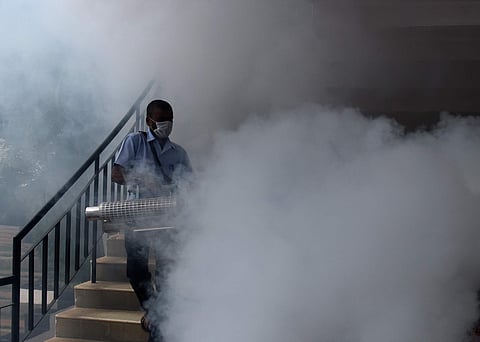 A man carries out mosquito fogging at Delhi Public School on Kanakapura Road on Wednesday  | Vinod Kumar T