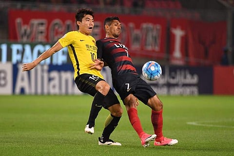 Guangzhou Evergrande skipper Zheng Zhi  (L)| AFP